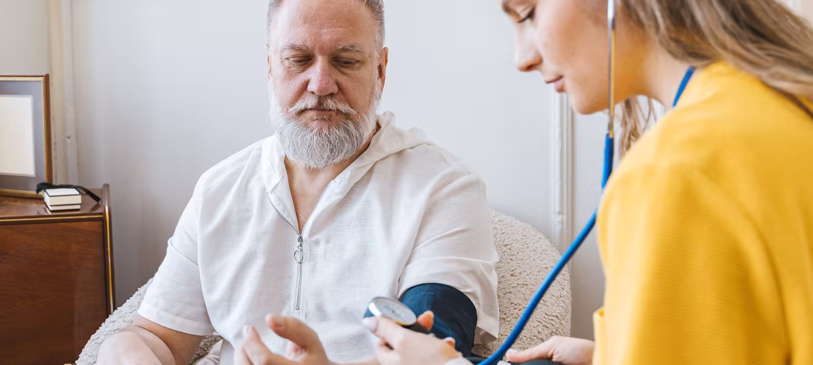 A nurse helping a patient in their home 